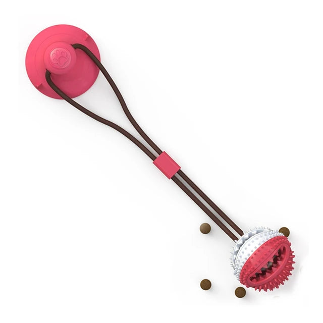 Pink treat-ball suction toy with treats beside the textured ball