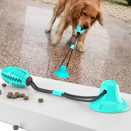 Golden retriever tugging a teal treat-ball suction dog toy